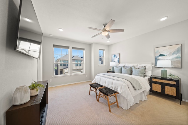 bedroom with baseboards, light carpet, and a ceiling fan