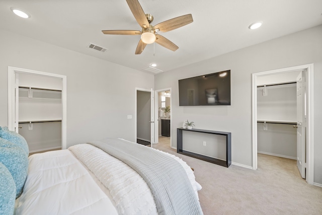 bedroom with visible vents, recessed lighting, ceiling fan, light carpet, and a walk in closet