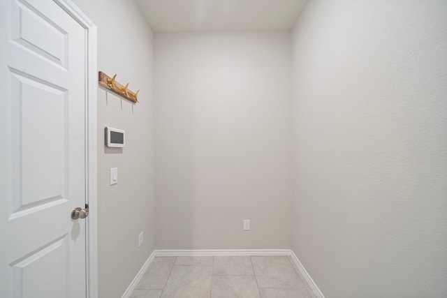 interior space featuring baseboards and light tile patterned flooring