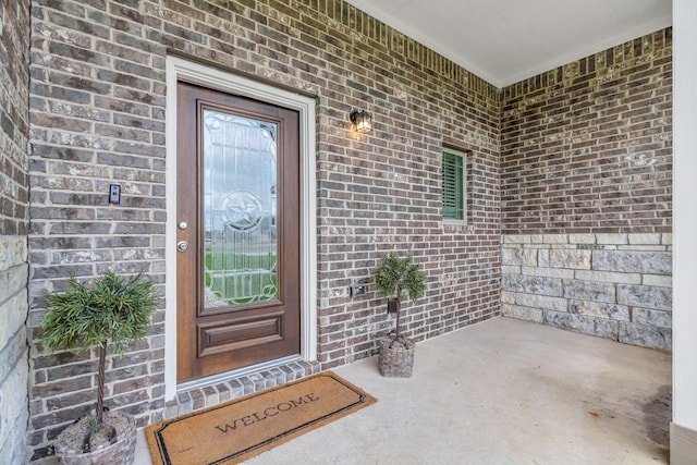 property entrance with brick siding