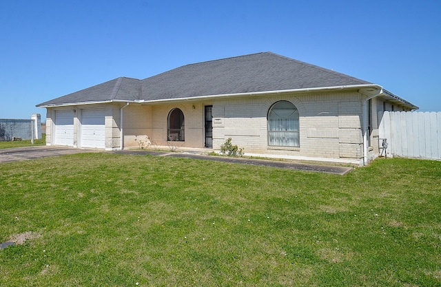 ranch-style house with a front lawn, a garage, brick siding, and driveway