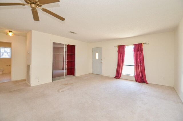 unfurnished room with carpet and visible vents