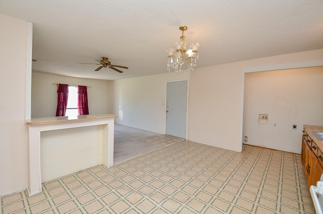 unfurnished room with light floors, a textured ceiling, and ceiling fan with notable chandelier