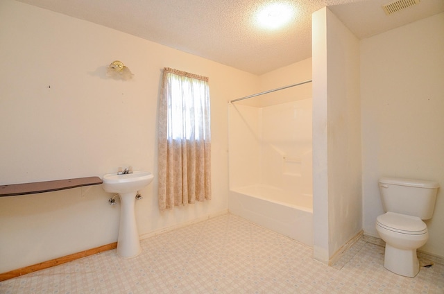 bathroom featuring visible vents, tub / shower combination, a textured ceiling, tile patterned floors, and toilet