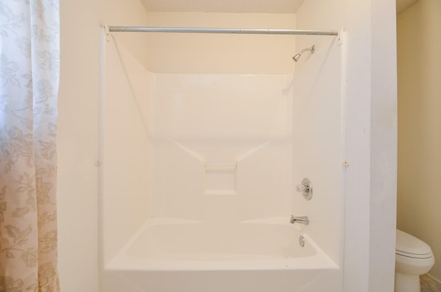 bathroom with toilet and shower / tub combo with curtain