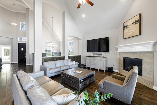 living room with dark wood-type flooring, plenty of natural light, and a fireplace