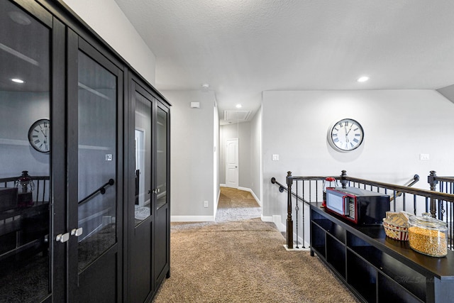 hall featuring an upstairs landing, recessed lighting, carpet floors, baseboards, and attic access