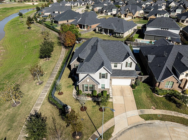 drone / aerial view featuring a residential view and a water view