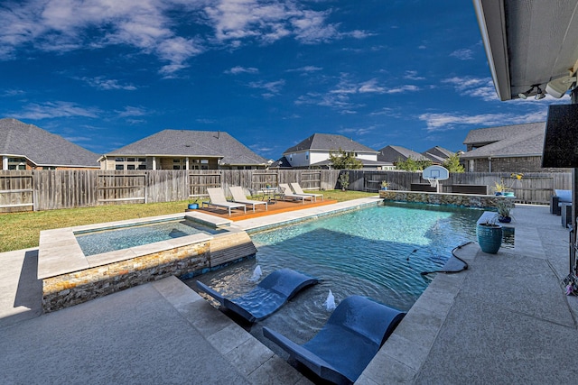 view of swimming pool with a lawn, a pool with connected hot tub, a fenced backyard, and a patio area