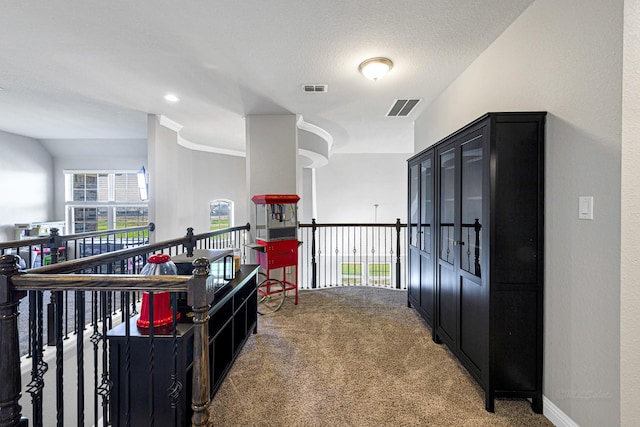 corridor featuring carpet, visible vents, and baseboards