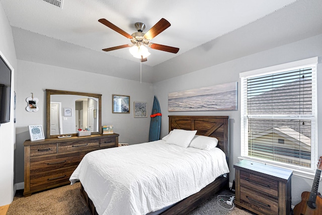 bedroom with lofted ceiling, carpet, and ceiling fan