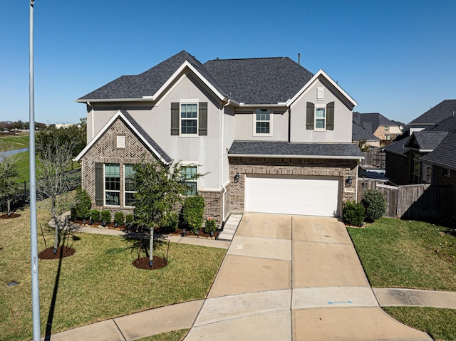 view of front of home featuring fence, stucco siding, concrete driveway, a front lawn, and brick siding