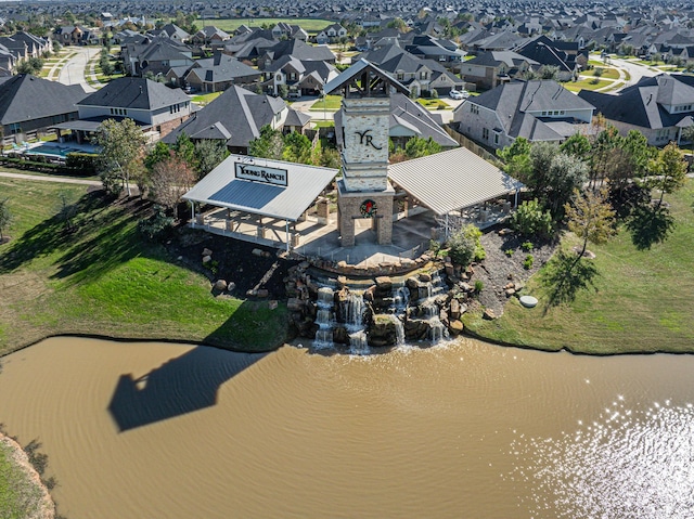 drone / aerial view featuring a residential view and a water view