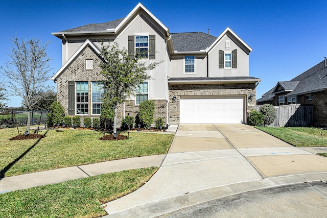 traditional home featuring brick siding, concrete driveway, a front yard, and fence