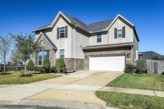 traditional home featuring brick siding, fence, concrete driveway, stucco siding, and an attached garage