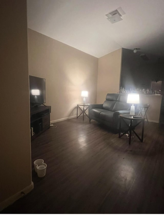 living room featuring wood finished floors and baseboards