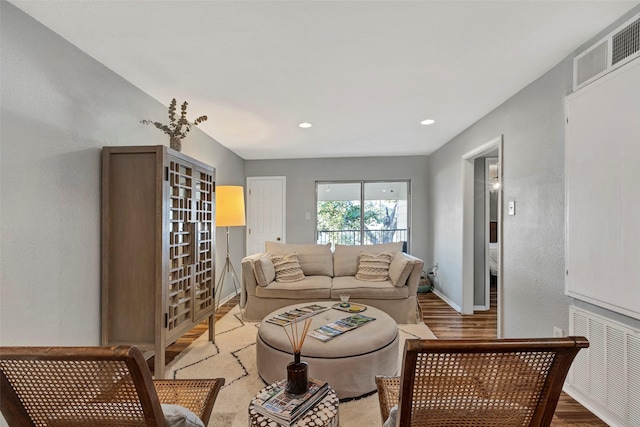 living room with visible vents, recessed lighting, radiator, light wood finished floors, and baseboards