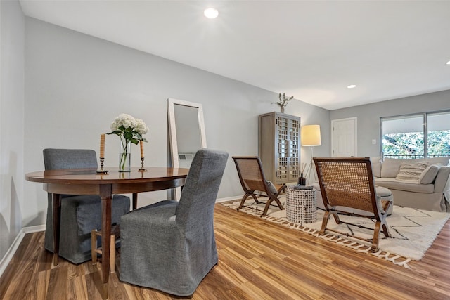 interior space featuring recessed lighting, baseboards, and wood finished floors