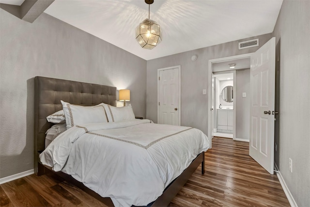 bedroom featuring visible vents, baseboards, and dark wood-style flooring