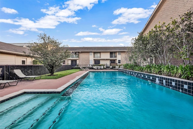 view of swimming pool with a fenced in pool, a patio, and fence