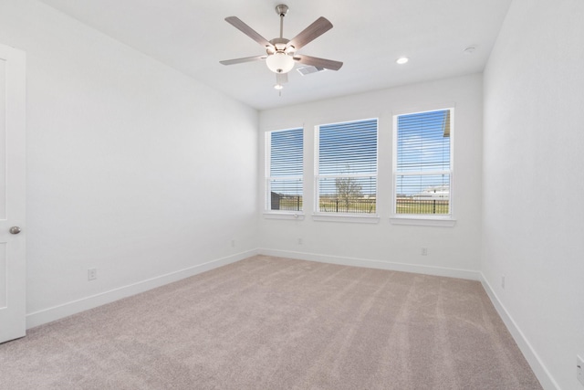 spare room featuring visible vents, baseboards, recessed lighting, ceiling fan, and light carpet