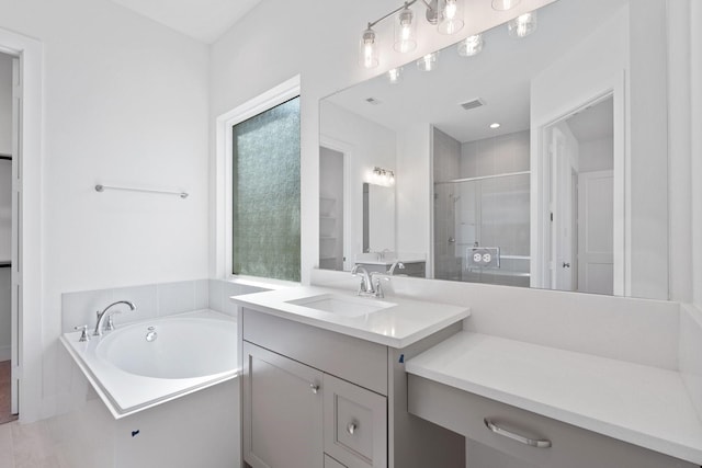 full bathroom featuring a bath, visible vents, a stall shower, and vanity