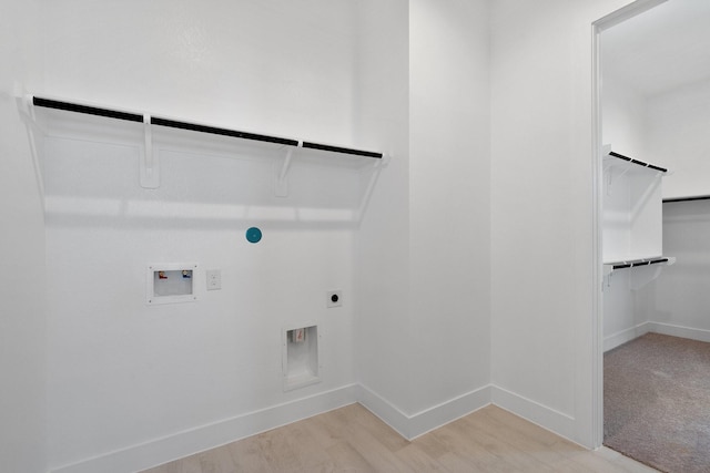 laundry area featuring light wood-style floors, baseboards, hookup for an electric dryer, hookup for a washing machine, and laundry area