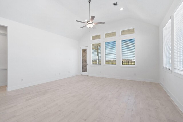 empty room with light wood-style flooring, visible vents, a wealth of natural light, and ceiling fan