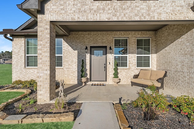 property entrance with brick siding