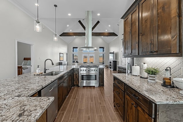 kitchen featuring light stone counters, wood finish floors, a sink, appliances with stainless steel finishes, and open floor plan