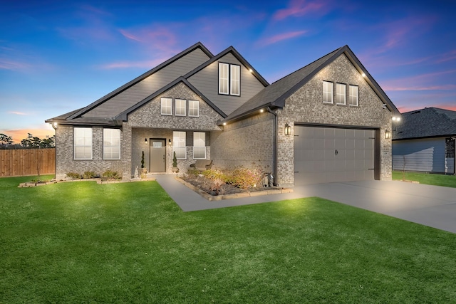 traditional home with a lawn, fence, concrete driveway, an attached garage, and brick siding