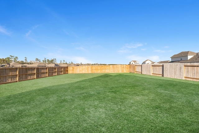 view of yard with a fenced backyard