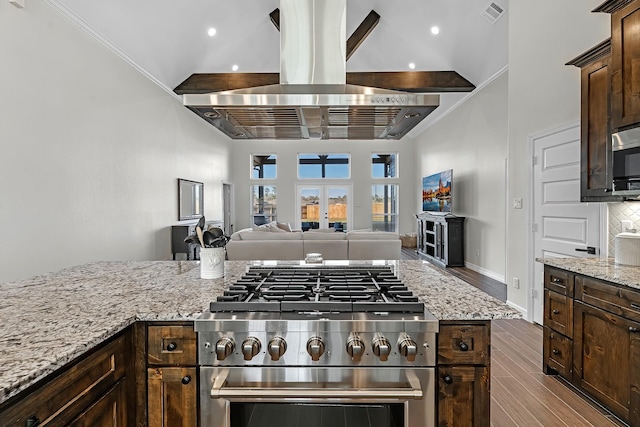 kitchen with visible vents, island exhaust hood, dark wood finished floors, dark brown cabinets, and high end range