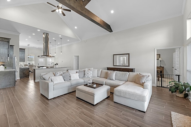 living area with wood tiled floor, ornamental molding, and high vaulted ceiling