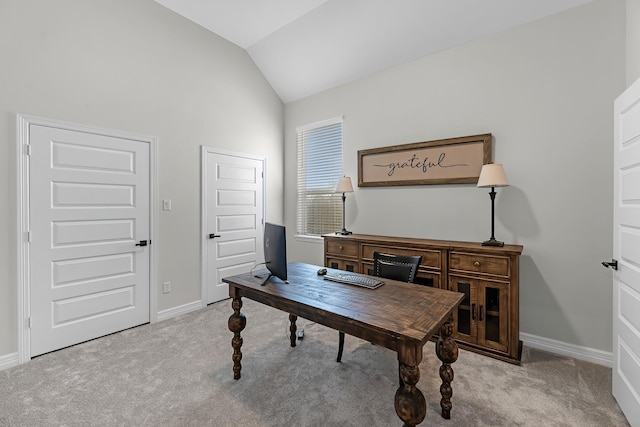 carpeted office with baseboards and vaulted ceiling