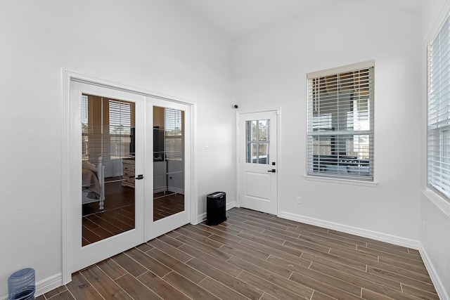 doorway to outside with french doors, baseboards, and wood tiled floor