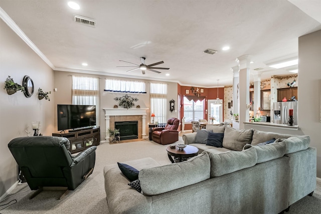 carpeted living area featuring visible vents, baseboards, and ornamental molding