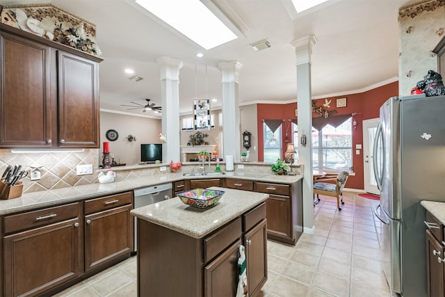 31331 Polaris Blvd, Tomball, TX 77375 - kitchen featuring freestanding refrigerator, ornate columns, crown molding, decorative backsplash, and a ceiling fan