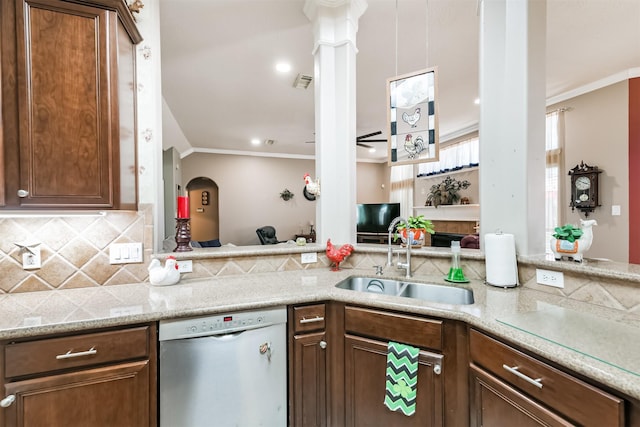 31331 Polaris Blvd, Tomball, TX 77375 - kitchen with dishwashing machine, ornamental molding, decorative backsplash, ornate columns, and arched walkways