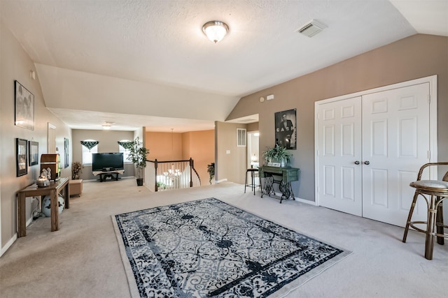 interior space featuring light carpet, visible vents, baseboards, and lofted ceiling