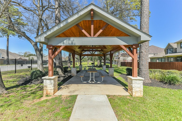 surrounding community with a gazebo, fence, a lawn, and a patio