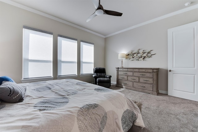 bedroom with crown molding, baseboards, carpet floors, and ceiling fan