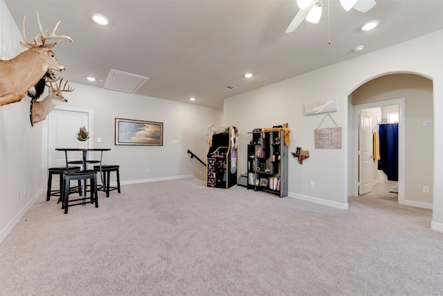 interior space featuring baseboards, carpet, ceiling fan, recessed lighting, and arched walkways