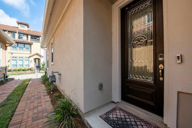 doorway to property with stucco siding