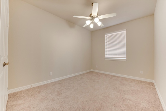 spare room with baseboards, carpet, and a ceiling fan