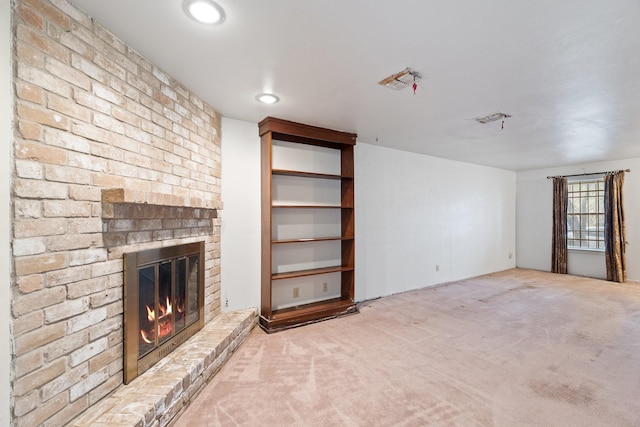 unfurnished living room featuring carpet and a fireplace