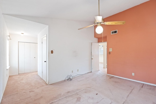 spare room with light carpet, visible vents, ceiling fan, and lofted ceiling