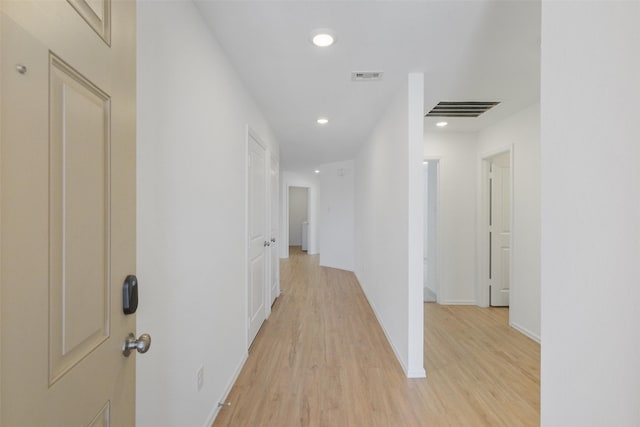 hall with light wood-style flooring, recessed lighting, visible vents, and baseboards