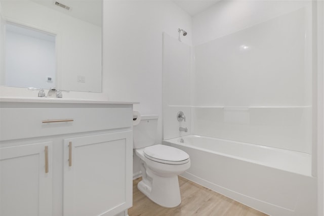 full bath featuring visible vents, toilet, wood finished floors, bathing tub / shower combination, and vanity