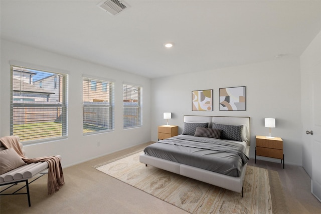 carpeted bedroom with recessed lighting, visible vents, and multiple windows